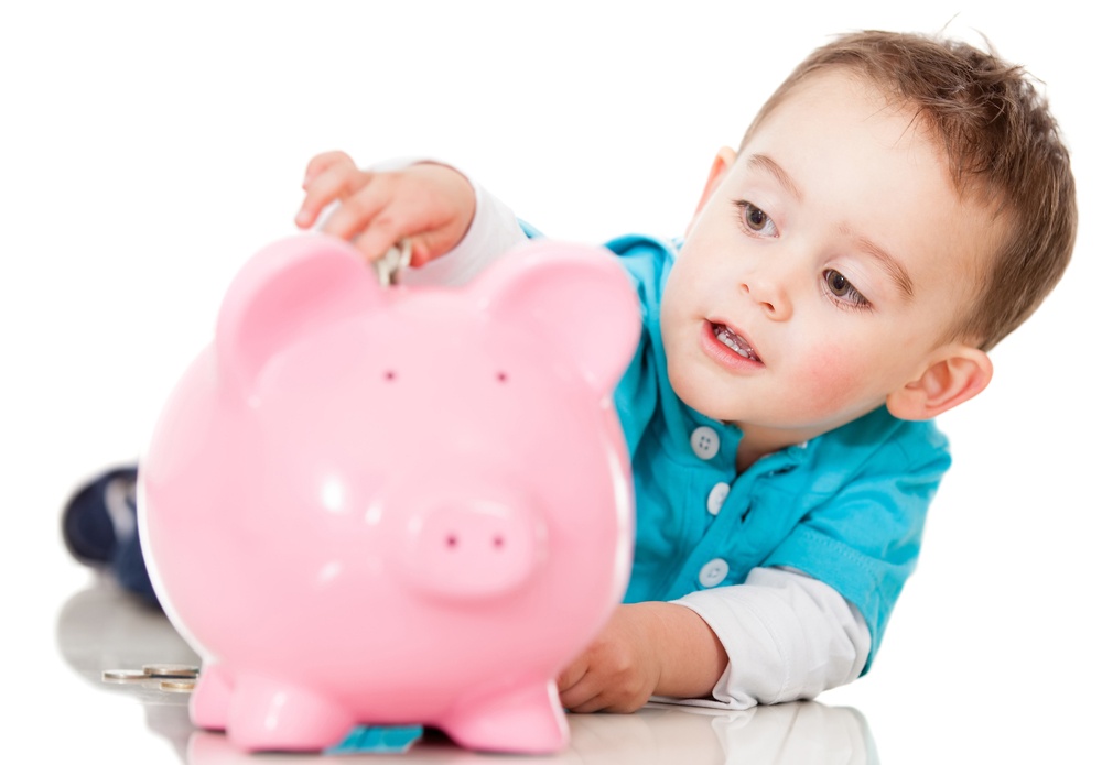 Boy saving money in a piggybank - isolated over a white background-2